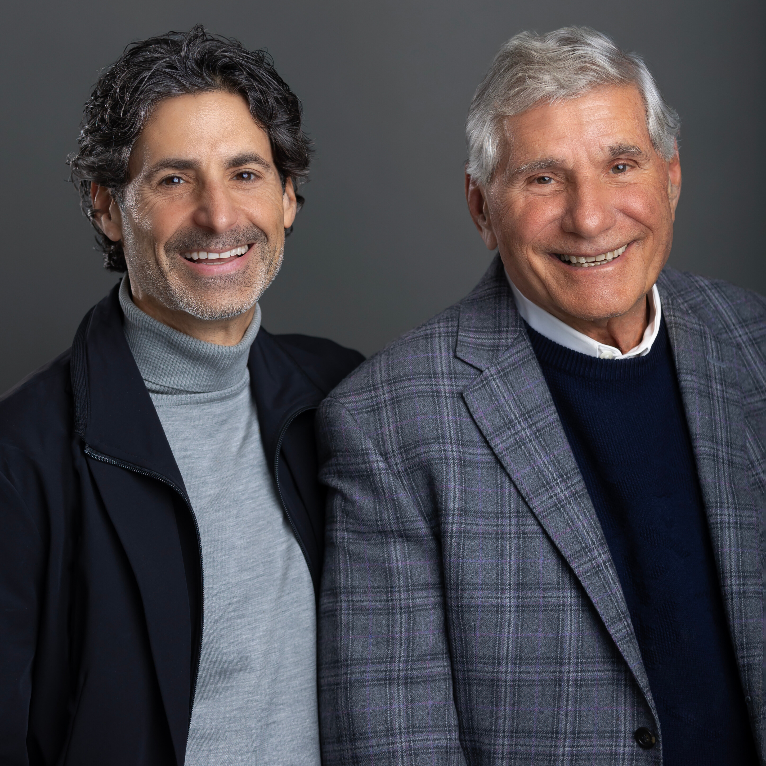 Managing Partner Charles Gluckstein poses alongside Founding Partner Bernard Gluckstein