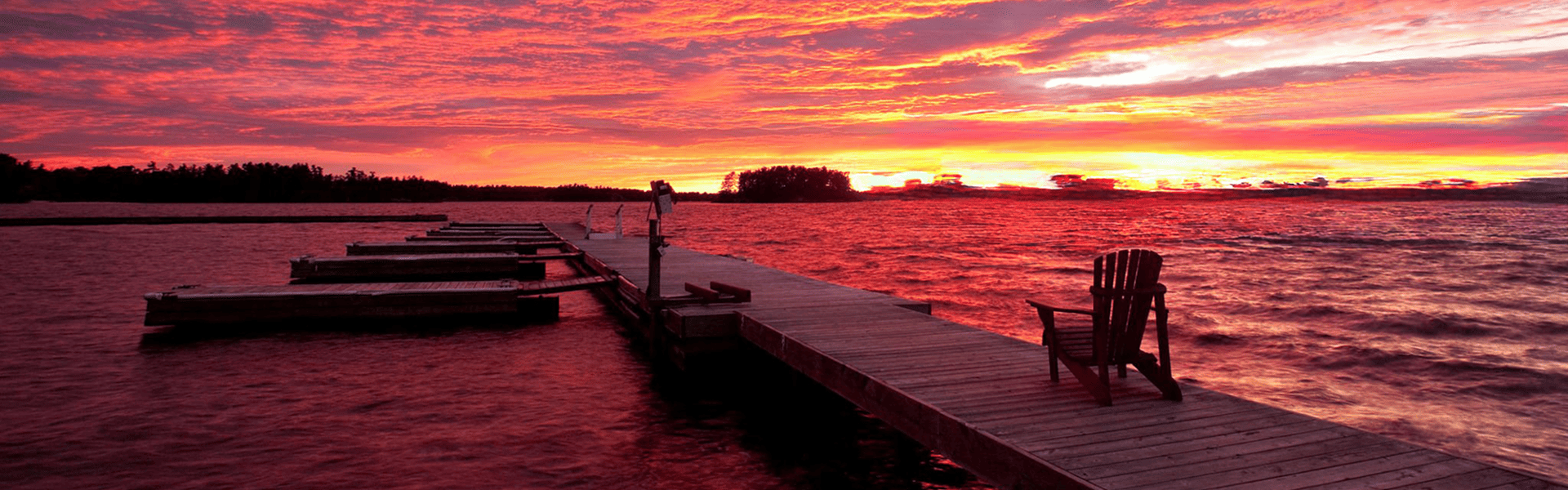 Muskoka Chair on a lake dock an sunset