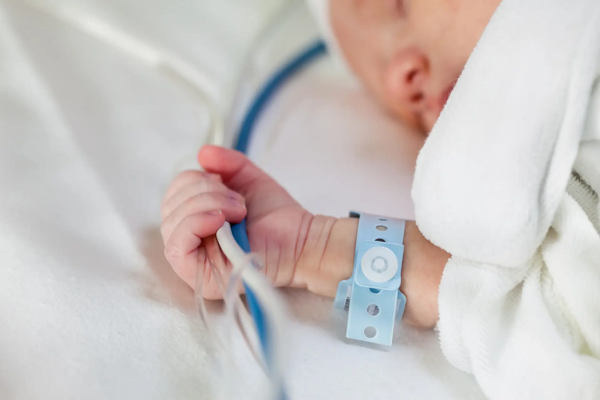 Infant holding IV lines