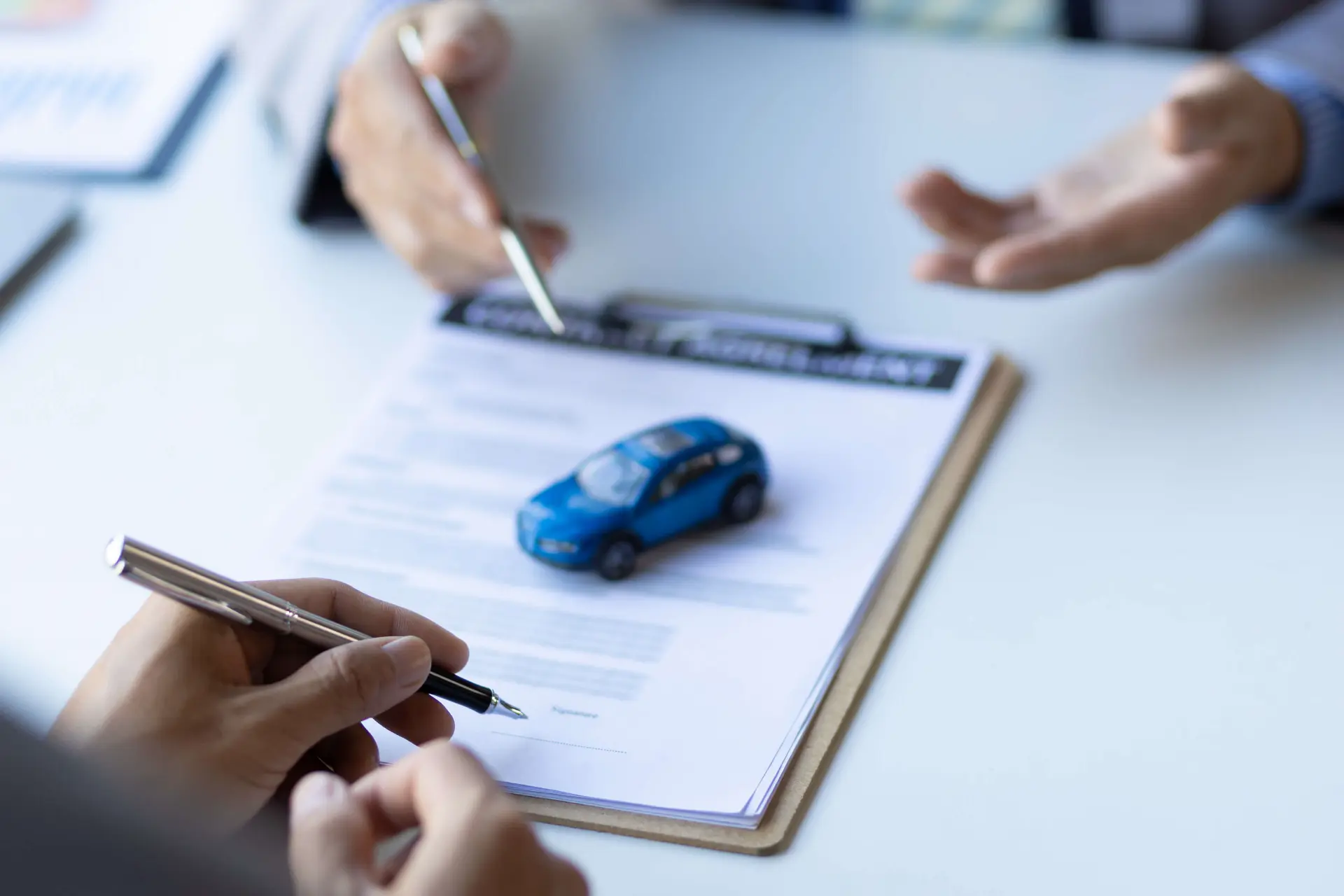 a person signs and reviews their auto insurance