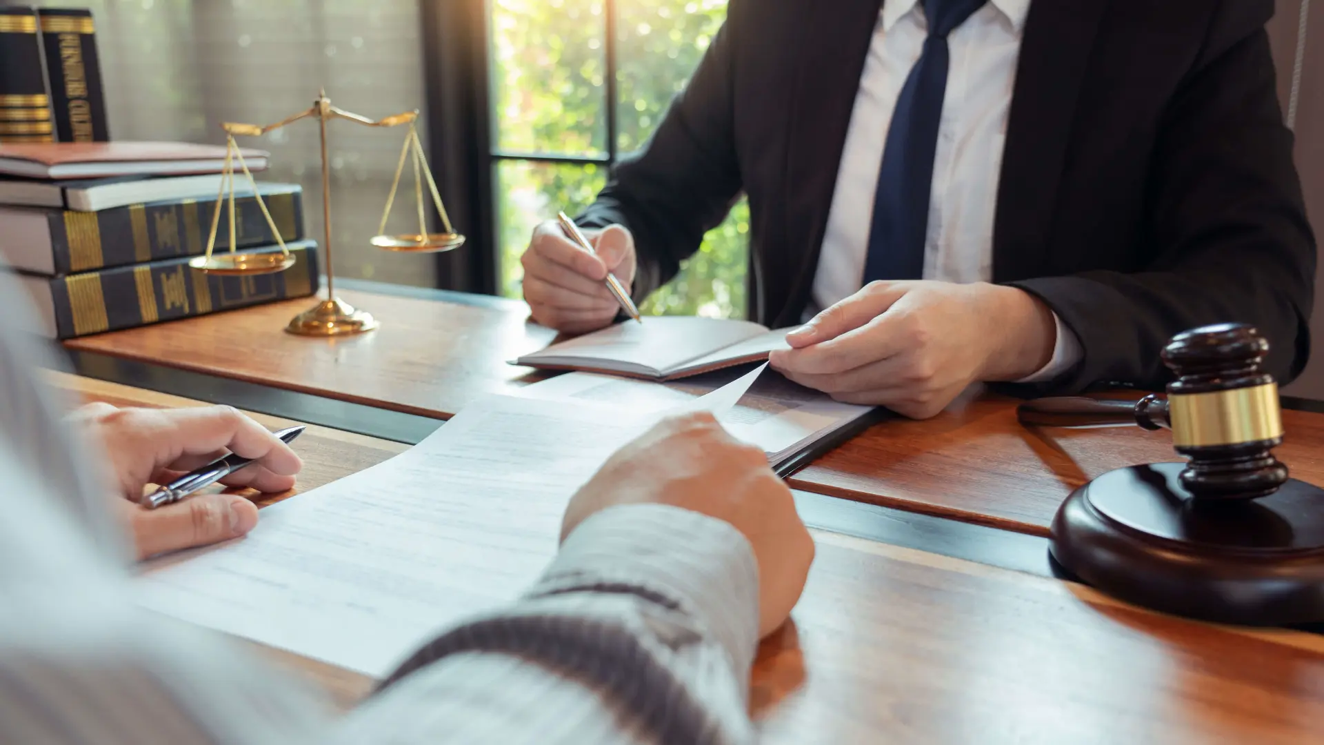 a person reviews documents with their lawyer