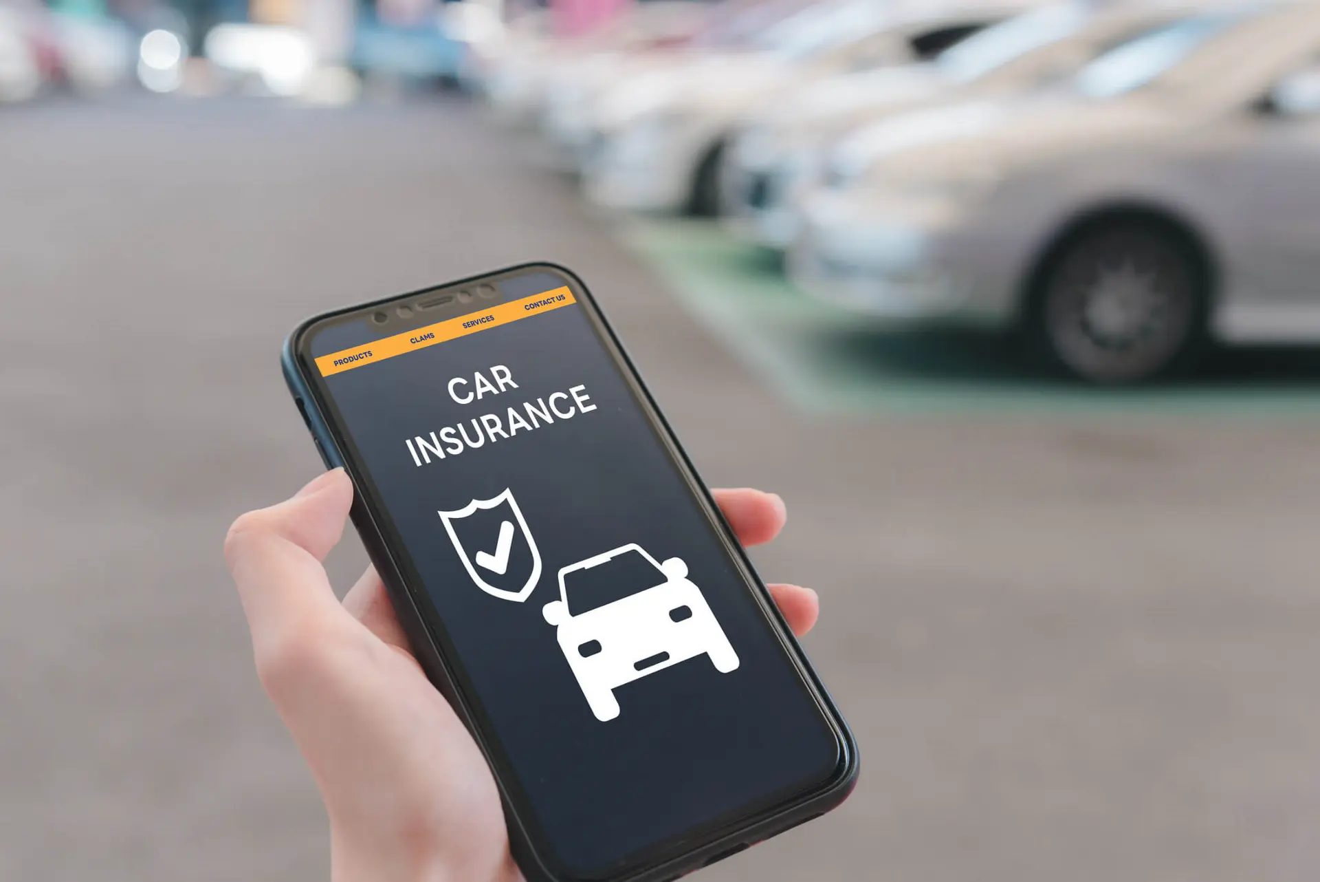 a person holds up their cellphone to confirm if they have car insurance