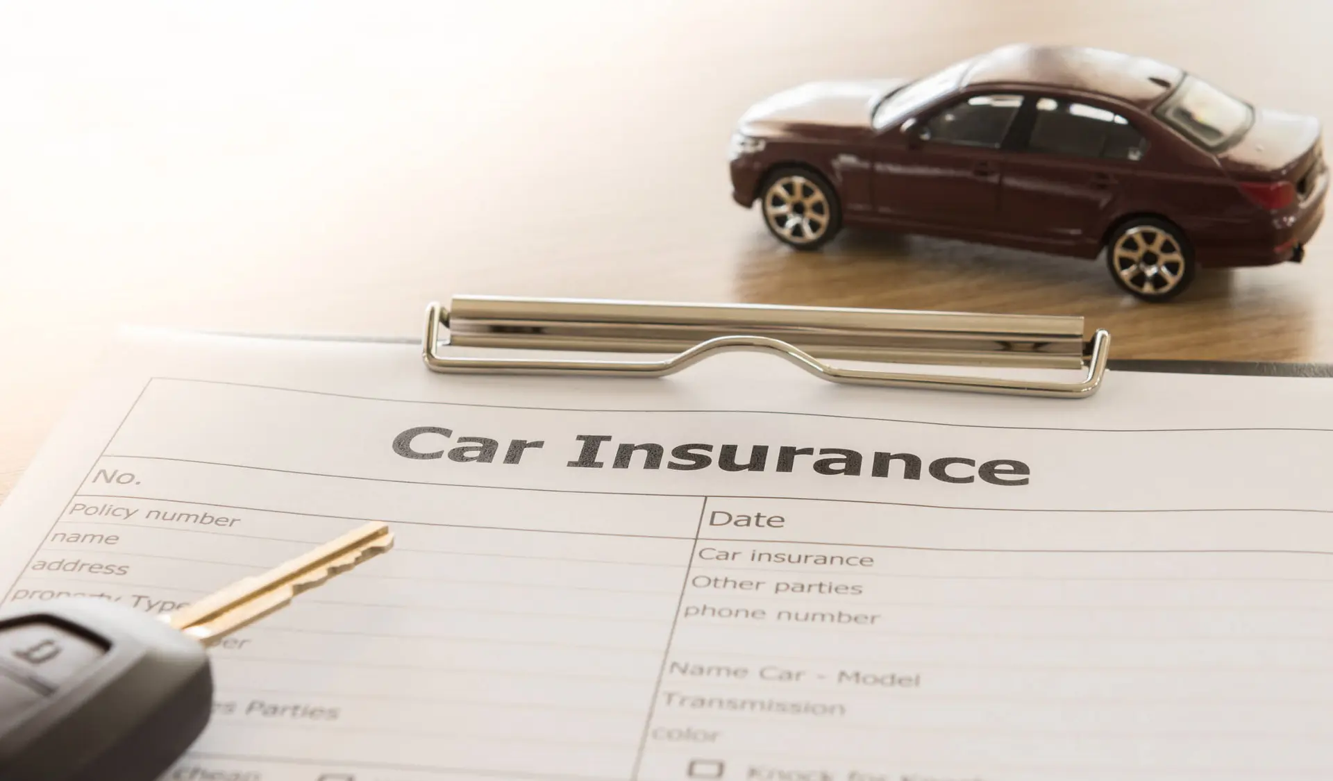 a car insurance plan is ready to be filled out on a clipboard