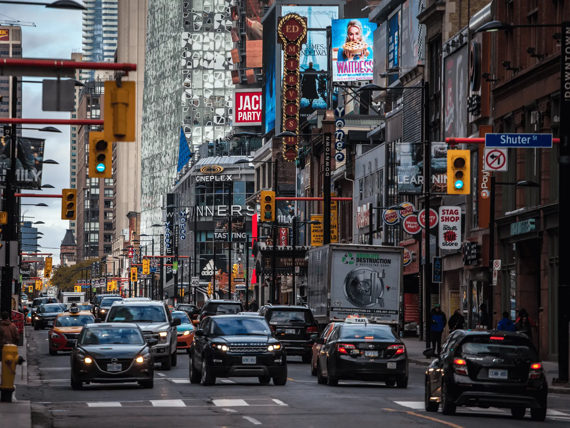 a street view of vehicle traffic in downtown Toronto at Shuter street