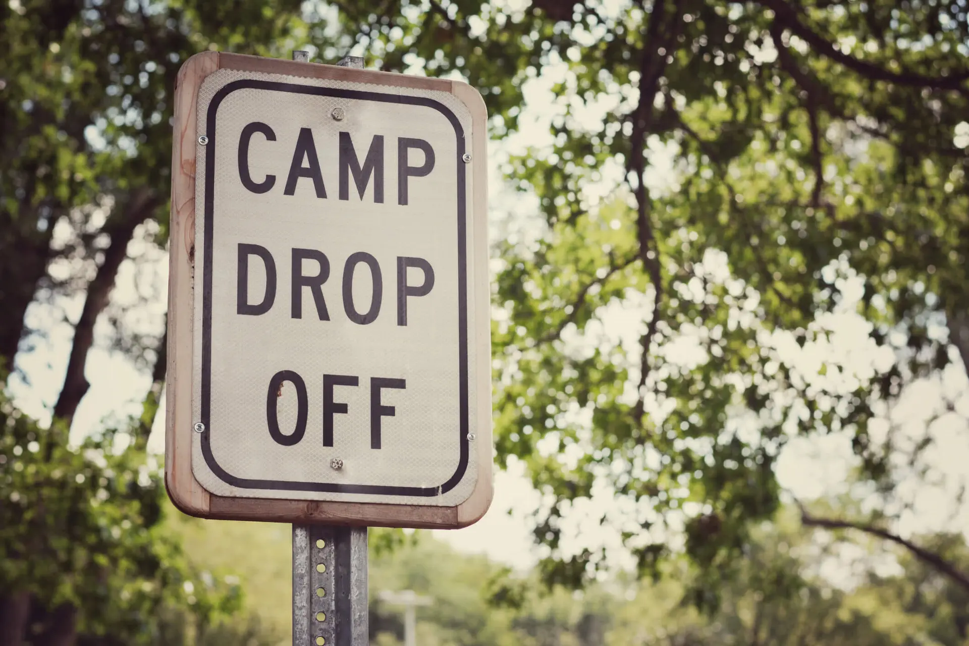 a camp drop sign for a sleepaway summer camp for children in nature