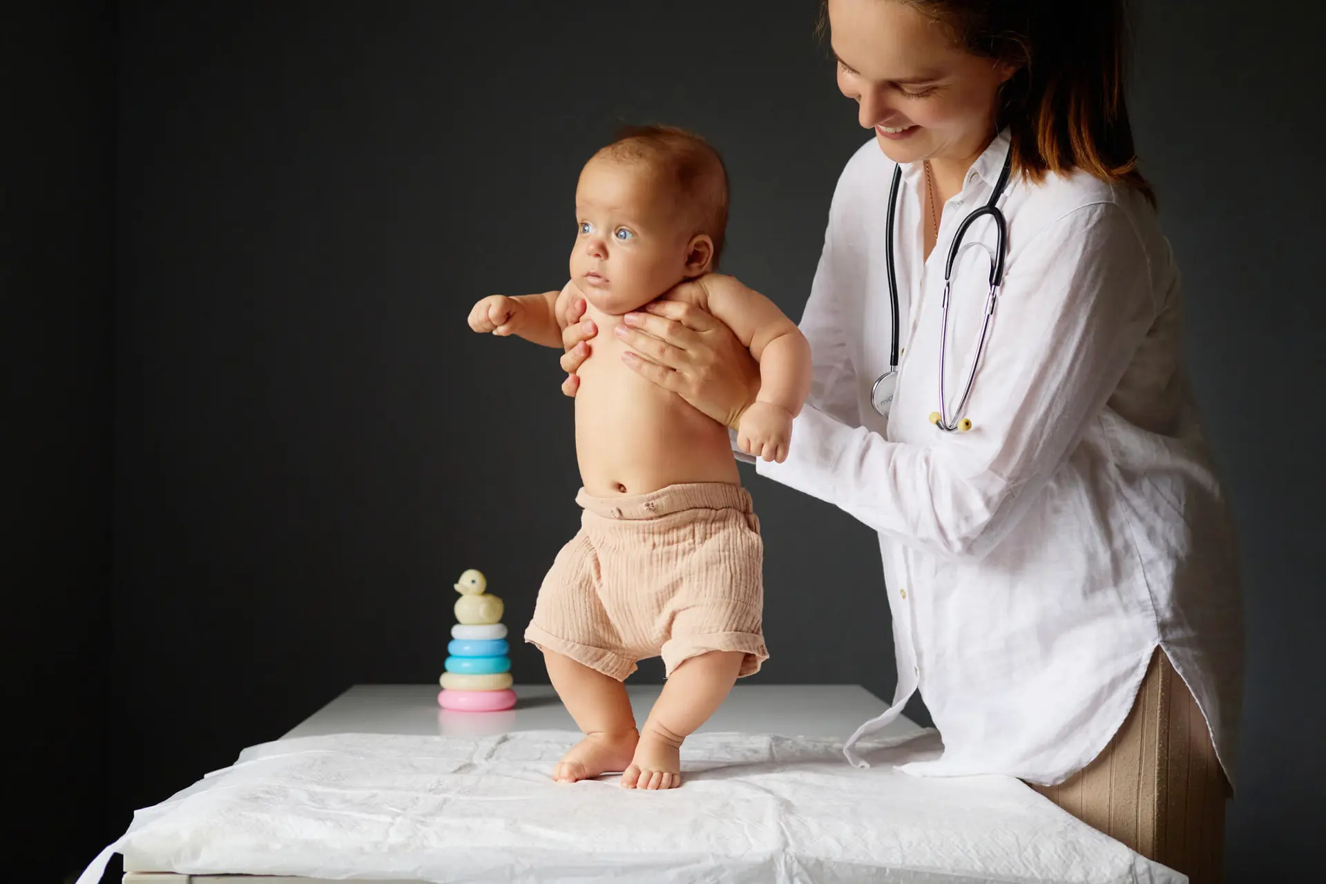 an infant gets screened for developmental disorders by his pediatrician