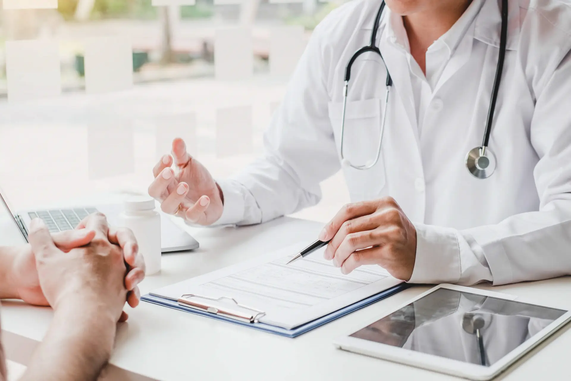 a person who has a disability is discussing their medical treatment with their family doctor to determine next steps