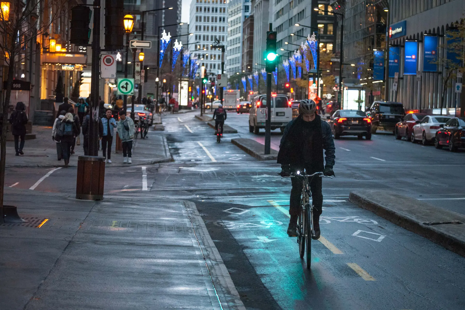 a cyclist rides their bicycle in a designated bike lane in downtown Toronto