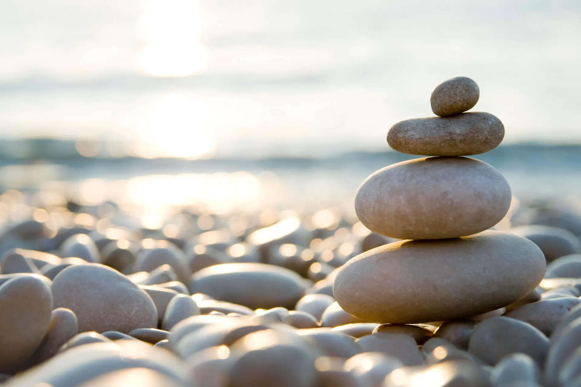 Balanced stones on a beach - concept of Compassion and Zen